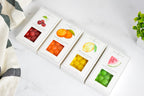 Jocelyn & Co. bright sours collection — Cherry, Orange, Lemon, and Watermelon candy boxes arranged together