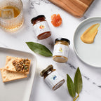 Jocelyn & Co. mustard collection in artisan jars, styled on a wood surface