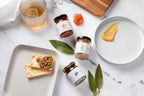 Jocelyn & Co. artisan jams and spreads collection in signature jars, styled on white surface