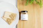 Jar of Jocelyn & Co. Chardonnay mustard with artisan label, lifestyle shot
