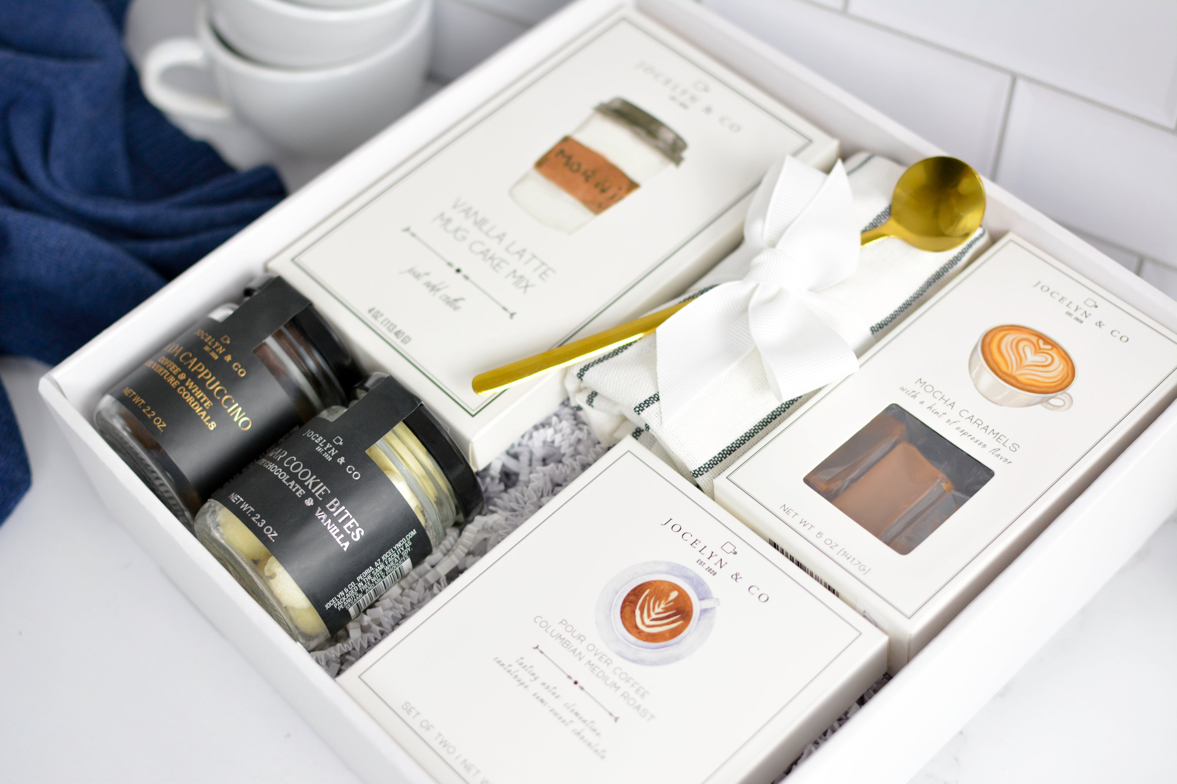 Coffee Gift set with jars and a spoon in a decorative box on a white surface.