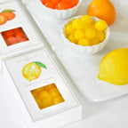 Jocelyn & Co. Lemon Sours candy packaging on marble surface with towel