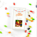 Jelly bean bag with 'Let's Celebrate' text surrounded by scattered jelly beans on a white background