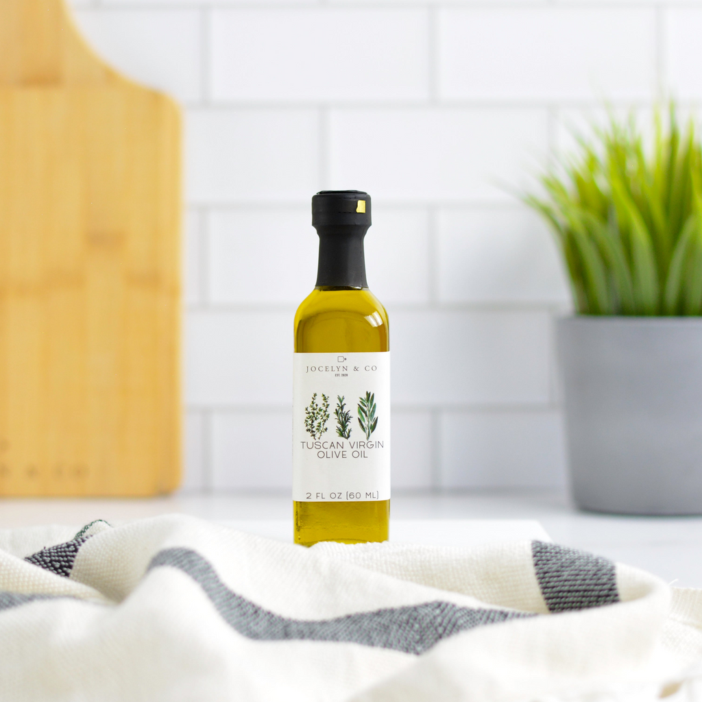 Bottle of Tuscan Virgin Olive Oil on a kitchen counter with a white tile background