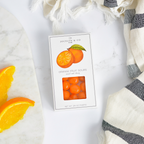 Jocelyn & Co. Orange Sours candy in bright orange signature packaging