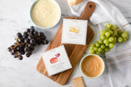 Jocelyn & Co. spreadable cheese collection — Camembert and Cabernet Cheddar — in luxe signature boxes